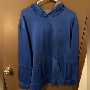 Two men’s hoodies. One is Oakley the other is a Simms fishing tech hoodie.
